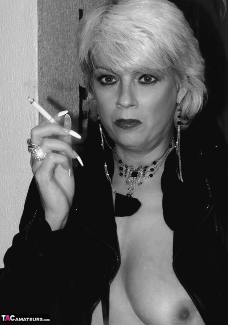 Older blonde lights a cigarette while showing her raw breasts and vagina - #674784
