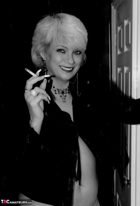 Older blonde lights a cigarette while showing her raw breasts and vagina - #674785