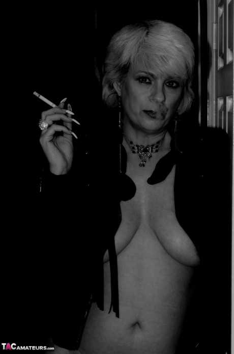 Older blonde lights a cigarette while showing her raw breasts and vagina - #674791