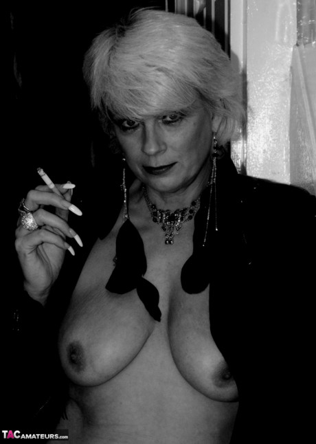 Older blonde lights a cigarette while showing her raw breasts and vagina - #674797