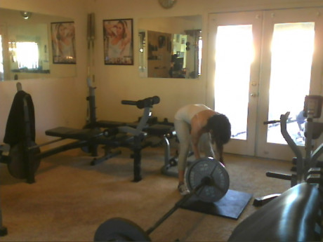 Sweet babe with amazing abs Tia flaunts her biceps at a home gym - #428247