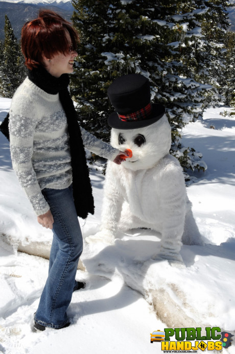 Dirty redhead Brandi de Lafey gives a snowman a CFNM handjob in the woods - #663435