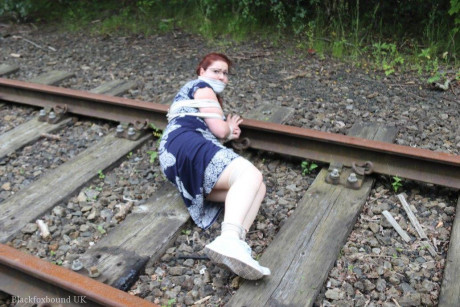 Fully clothed ginger is left gagged and bound on railway tracks