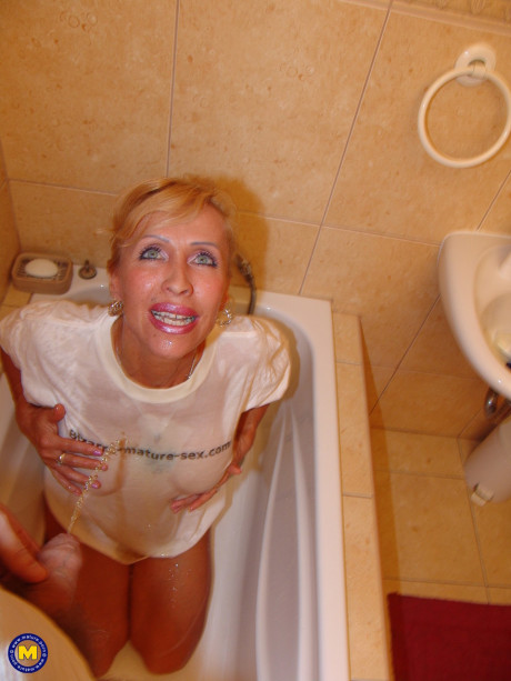 Amateur old lady Marcia gets pissed on in the tub and masturbates on the sofa - #1168421