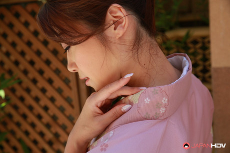 Japanese sweetie Maki Hojo shows her bush while outdoors in the garden - #1012384