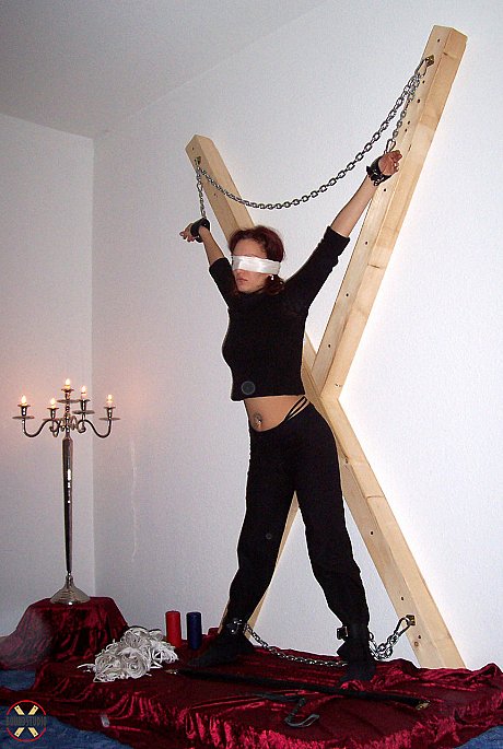 Blindfolded red hair Lilu Natilova is chained to a St Andrew's Cross - Image 5 of 16  in Bondage category   featuring Lilu Natilova 