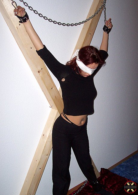 Blindfolded red hair Lilu Natilova is chained to a St Andrew's Cross - Image 6 of 16  in Bondage category   featuring Lilu Natilova 