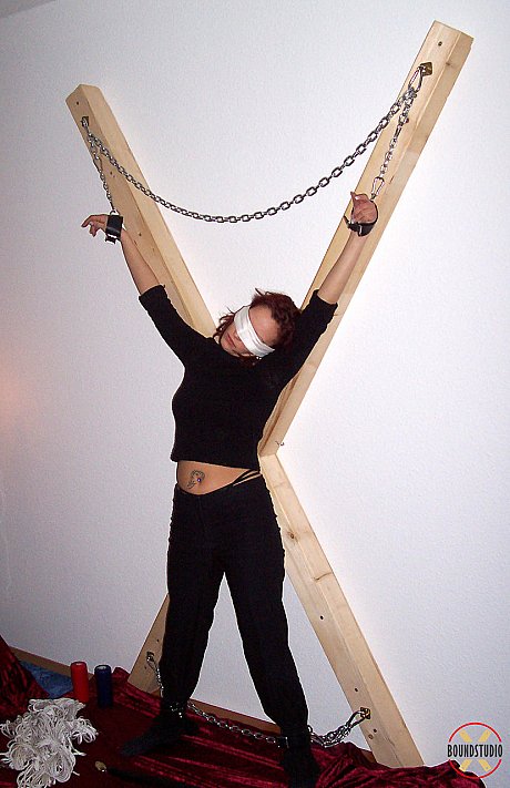 Blindfolded red hair Lilu Natilova is chained to a St Andrew's Cross - Image 10 of 16  in Bondage category   featuring Lilu Natilova 