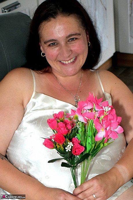 Mature BBW Cheeky Dee holds a bouquet of flowers before getting nude - Image 2 of 16  in Nipples category   featuring Cheeky Dee 
