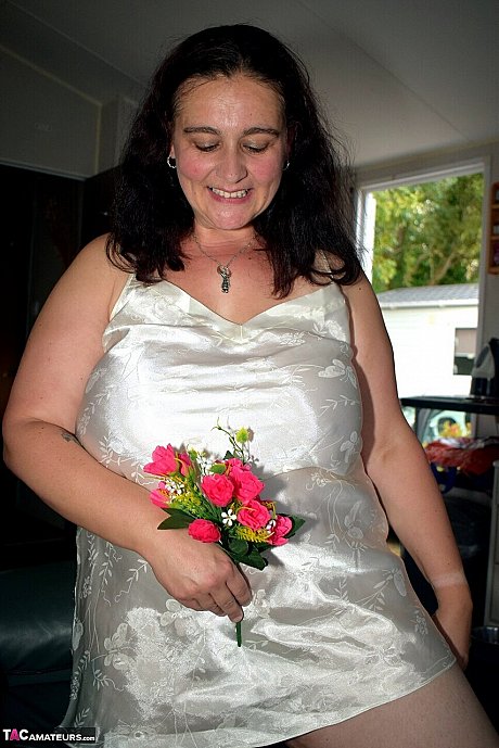 Mature BBW Cheeky Dee holds a bouquet of flowers before getting nude - Image 4 of 16  in Nipples category   featuring Cheeky Dee 