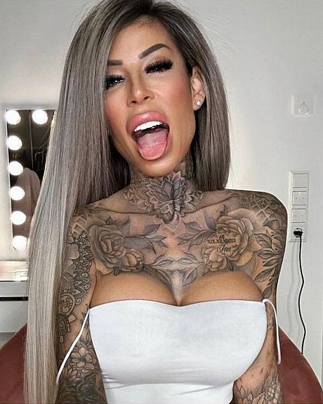 Tattooed amateur babe poses in pink fishnets & flaunts her hot legs & cleavage - Image 1 of 12  in Model category  
