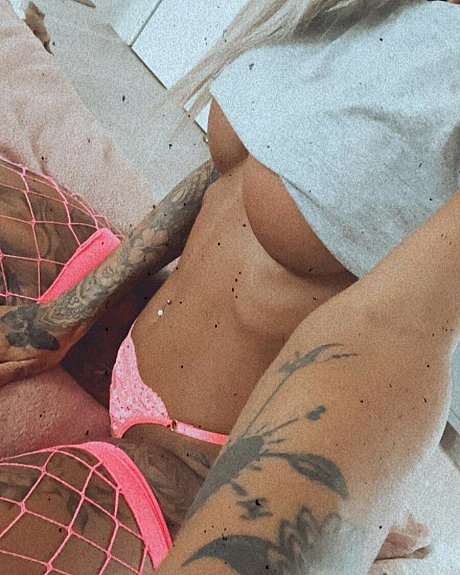 Tattooed amateur babe poses in pink fishnets & flaunts her hot legs & cleavage - Image 6 of 12  in Model category  