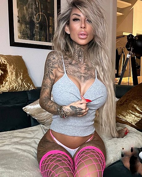Tattooed amateur babe poses in pink fishnets & flaunts her hot legs & cleavage - Image 8 of 12  in Model category  