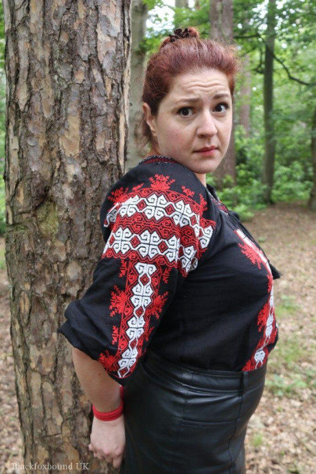 Chunky redhead is cleave gagged and tied to a tree in a forest - #812590