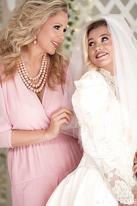 Carolina Sweets is affixed with a garter before a lesbian wedding to Julia Ann - Image 6 of 15  in Lesbian category   featuring Carolina Sweets, Julia Ann 