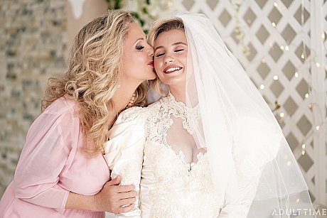Carolina Sweets is affixed with a garter before a lesbian wedding to Julia Ann - Image 7 of 15  in Lesbian category   featuring Carolina Sweets, Julia Ann 