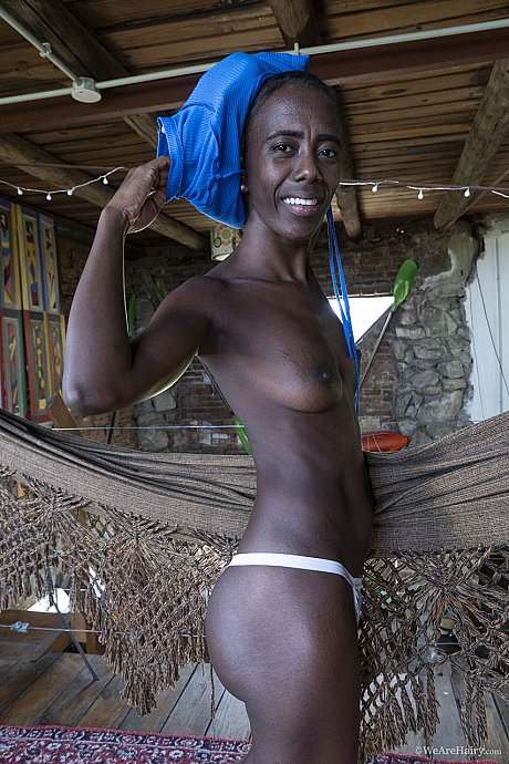 Skinny ebony babe Luz M flaunts her small boobies during a charming striptease