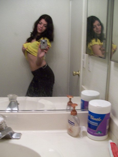 Dark haired teenie takes selfies of her nice booty & natural boobies in the mirror