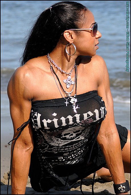 Ebony bodybuilder Stacy Simons flexes on a beach while wearing sunglasses - Image 8 of 15  in Outdoor category   featuring Stacy Simons 