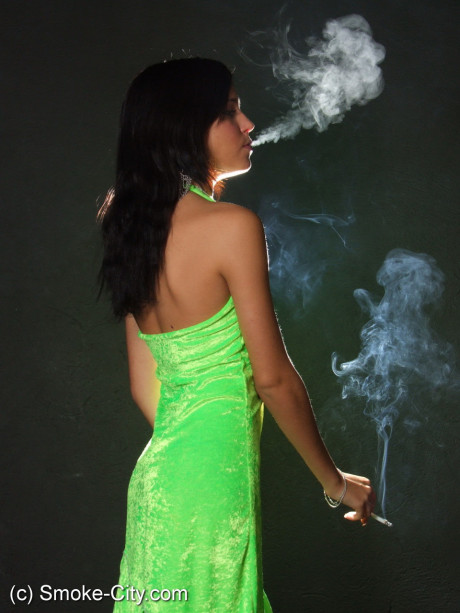 Dark haired young wears a lime dress and pointy heels while smoking - #677277