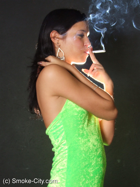 Dark haired young wears a lime dress and pointy heels while smoking - #677280