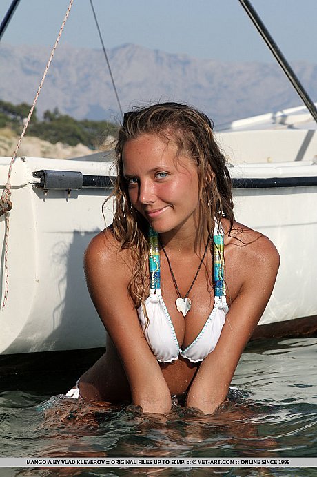 Lovely teen Mango A doffs bikini on boat to show tiny titties and bald vagina - Image 2 of 18  in Model category   featuring Mango A
