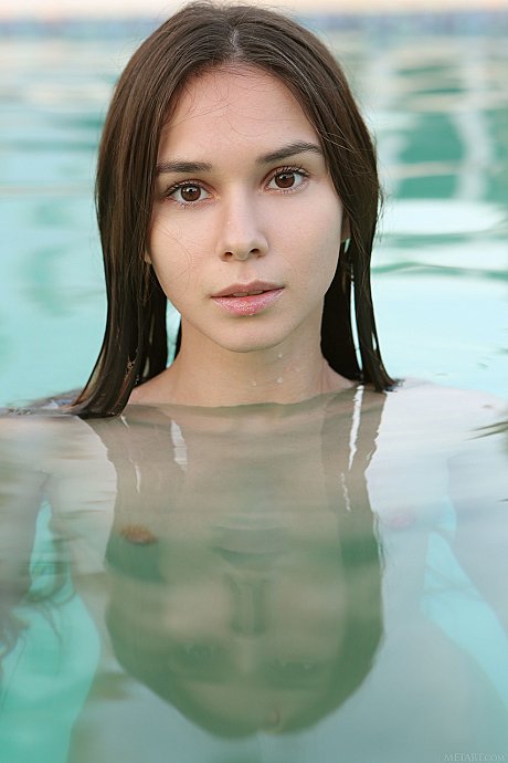 Adorable young Leona Mia strips and fondles her tiny boobs in the pool - Image 14 of 20  in Ass category   featuring Leona Mia 