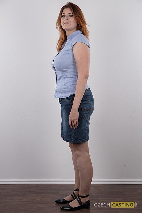 Overweight red hair Eva stands straight while clothed and totally undressed too