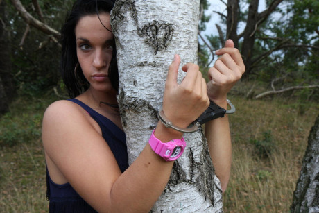 Brunette girl GF woman Nora is handcuffed to a tree while wearing a pink G-Shock watch - #542040