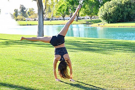 Teenage hottie in cute outfit Zoe doing exercise outdoors by the water - Image 4 of 20  in Model category   featuring Zoe Bloom 