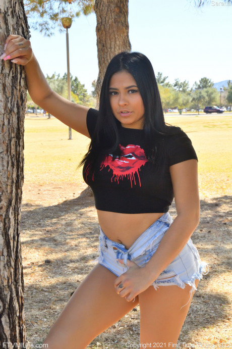 Curvy teen Serena teases with her amazing behind while posing in shorts in a park - #916364
