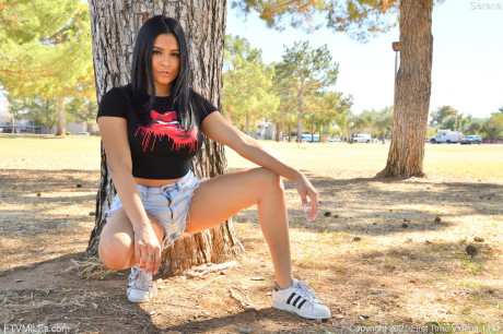 Curvy teen Serena teases with her amazing behind while posing in shorts in a park - #916372