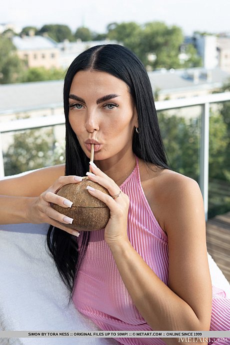 Dark haired young Simon gets nude on a deck while drinking from a coconut - Image 2 of 18  in Pussy category   featuring Simon 