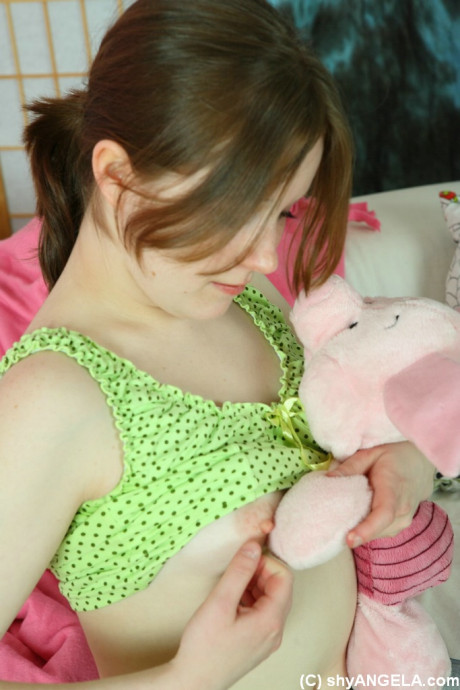 Pretty young teenie whore gf chick Angela uncovers her tiny boobs while playing with a plush toy - #472971