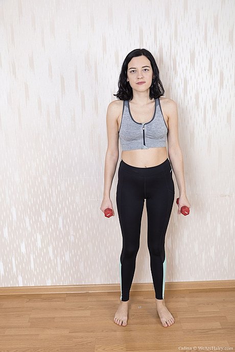 American newbie Calina spreads her bushy muff while lifting weights behind nude - Image 1 of 21  in Pussy category   featuring Calina 