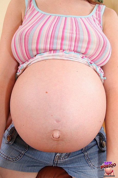 Pregnant amateur strips to her socks on a couch in a confident manner - Gallery #2030