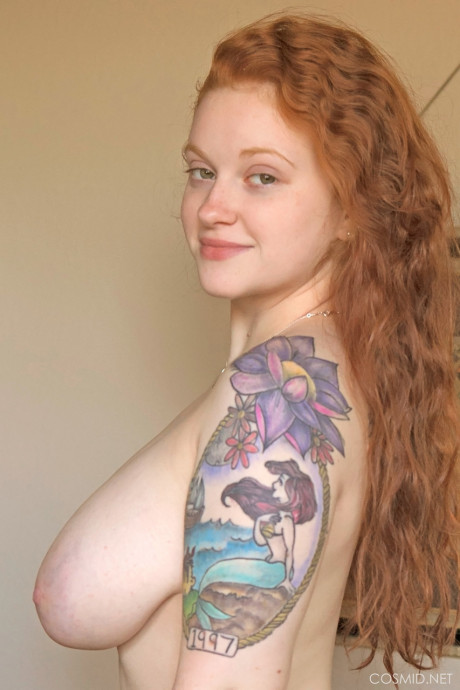 Tattooed red hair with giant floppy breasts romping undressed on the bed - #1034255