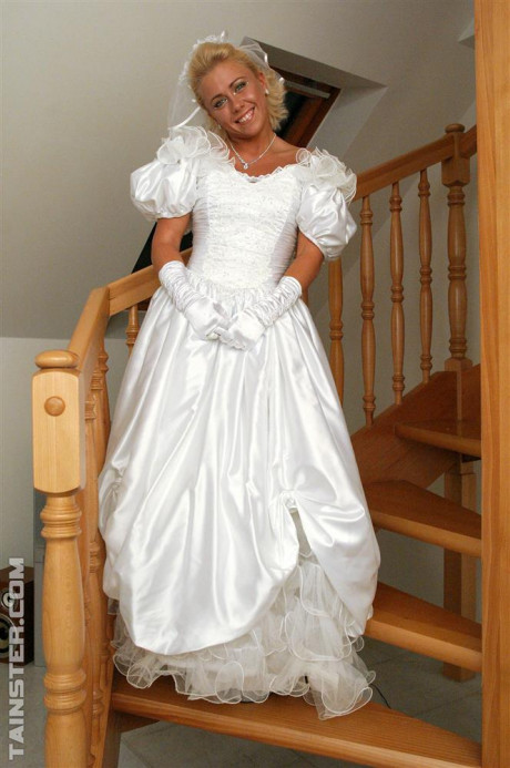 New bride dressed in her wedding dress plays water sport games at reception - #1100075