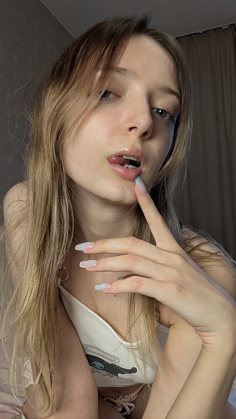 Solo bitch GF broad Shy Imp shows her long tongue while kneeling upon her bed - Image 7 of 10  in Teen category   featuring Shy Imp 