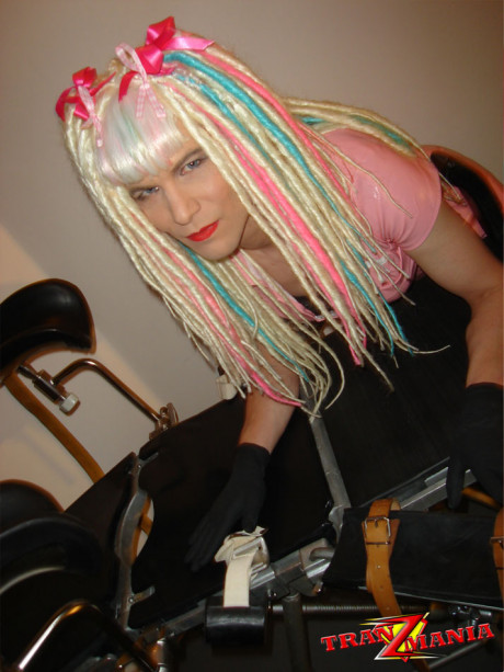 Naughty crazy haired crossdresser wearing pink pvc gets ready to go on the