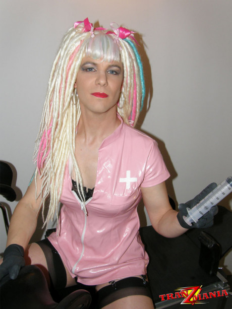 Naughty crazy haired crossdresser wearing pink pvc gets ready to go on the - #775975