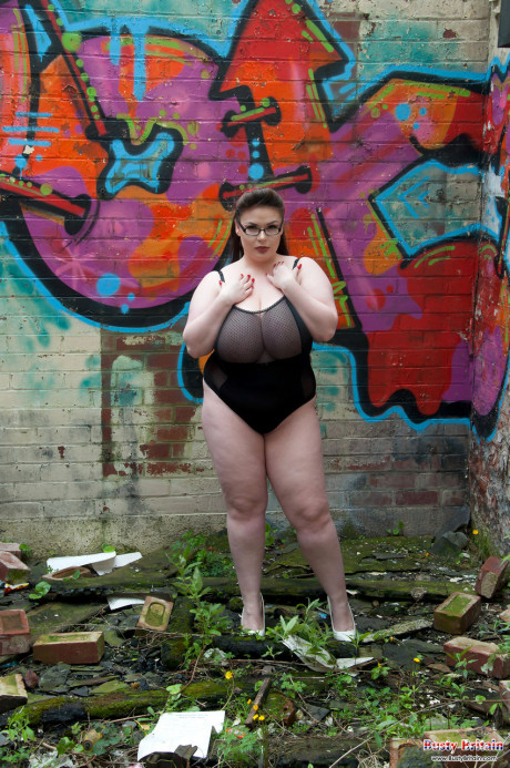 Brunette fatty Gina G unleashes her knockers while getting undressed near graffiti - #1336008