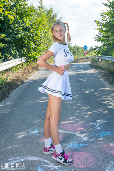 Blonde teenie Nana strips to her socks and runners on a paved road - #346056