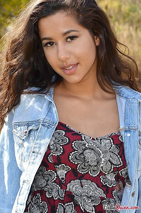 Latina first timer Bella Quinn covers up her exposed boobies in a field