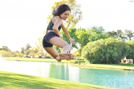 Teenage cutie in sexy outfit Zoe doing exercise outdoors by the water - #650827