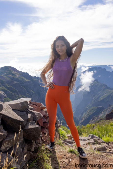 Hispanic Irene Rouse poses in her yoga pants & shirt on a mountian top - #644750