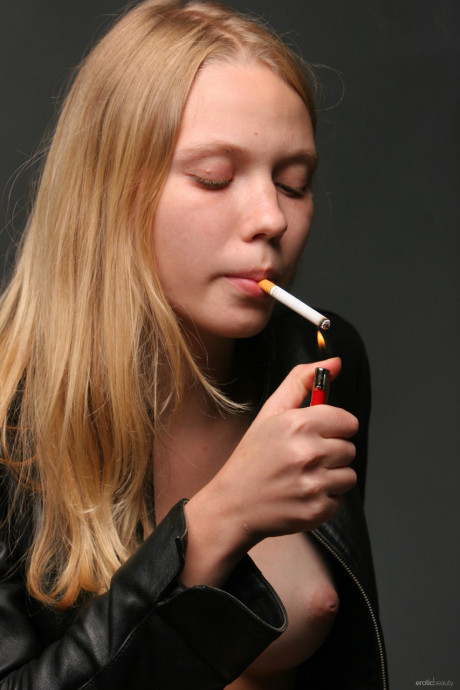 Erotic teen Polly A shows her boobies and vagina while smoking a cigarette