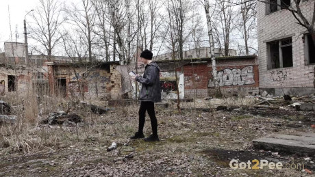 Short taken lady girl chick Alexa pisses atop a toilet outside of an abandoned building