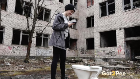 Short taken lady girl chick Alexa pisses atop a toilet outside of an abandoned building - #1332257