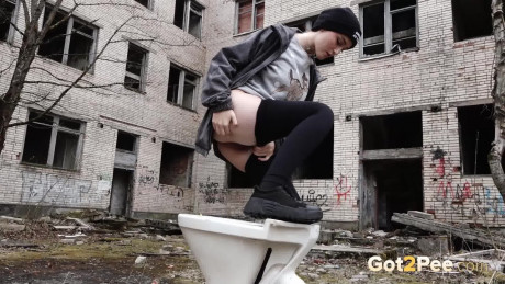 Short taken lady girl chick Alexa pisses atop a toilet outside of an abandoned building - #1332259